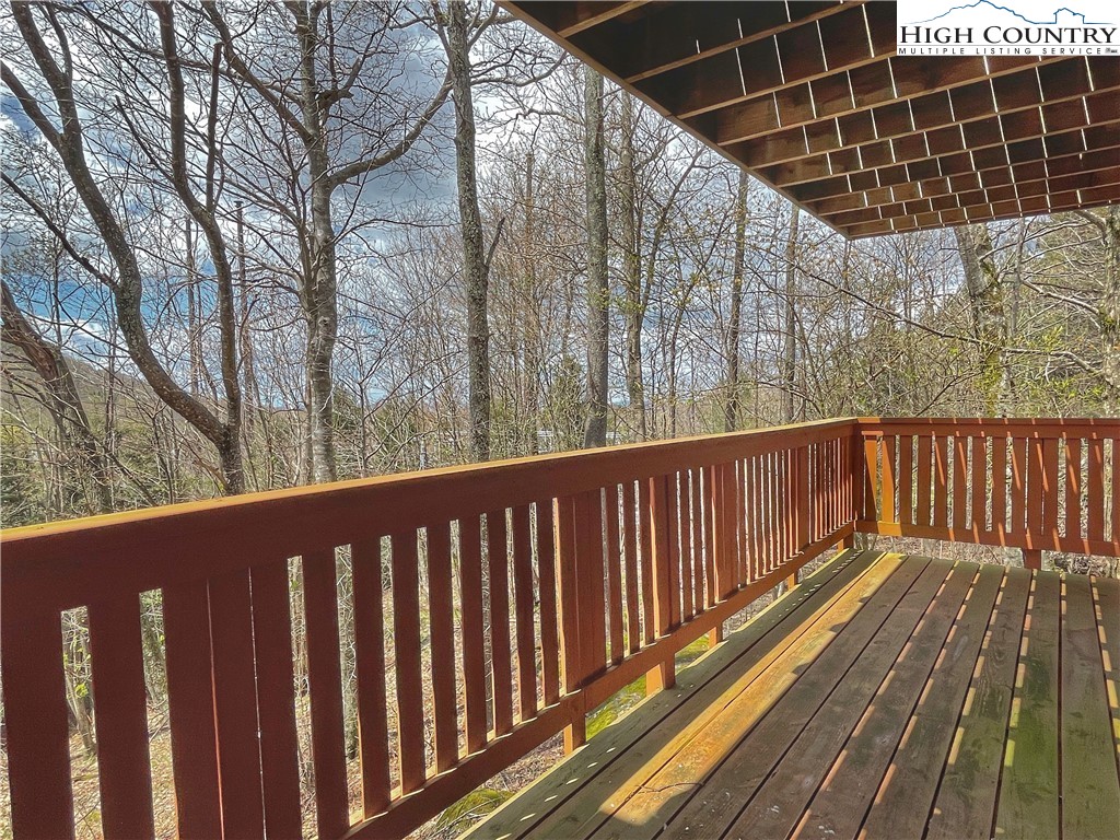 102 Skiview Lane, Unit A3 Beech Mountain, NC 28604 - Photo 16 of 20 a balcony view with wooden floor and fence