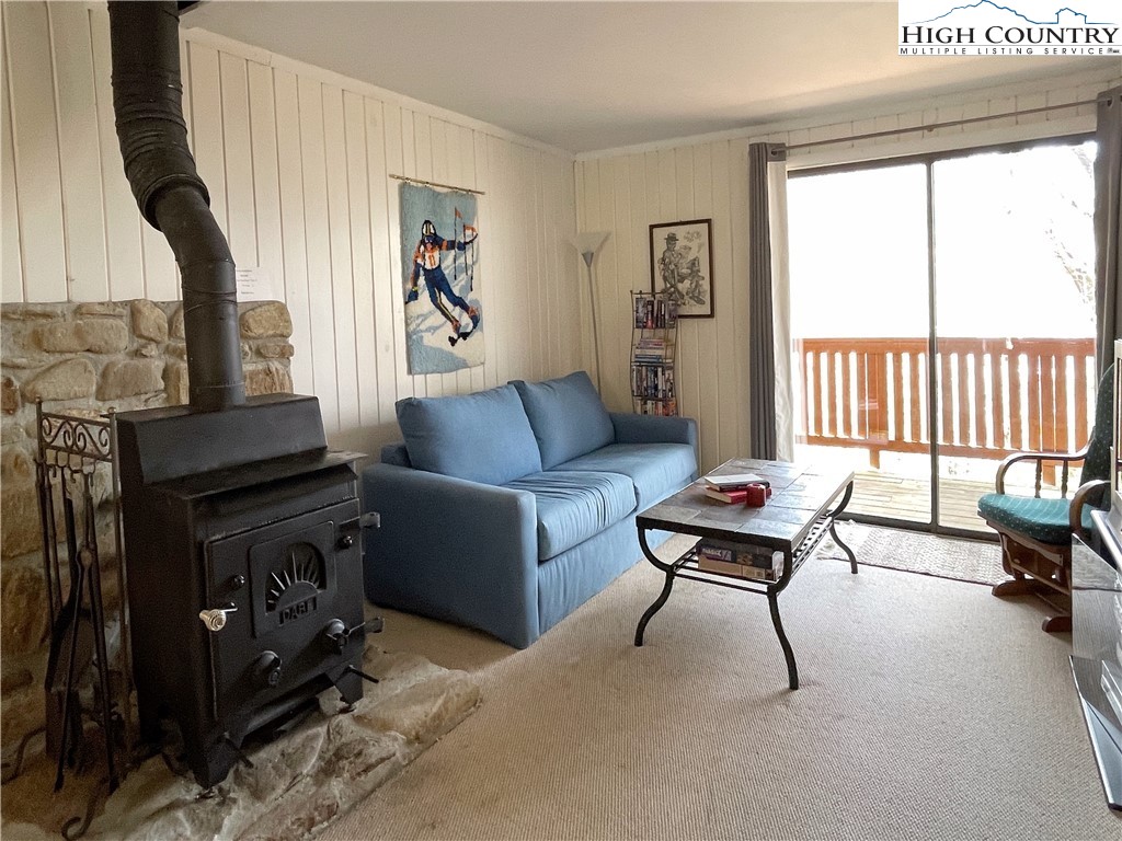 102 Skiview Lane, Unit A3 Beech Mountain, NC 28604 - Photo 6 of 20 a living room with furniture and a fireplace