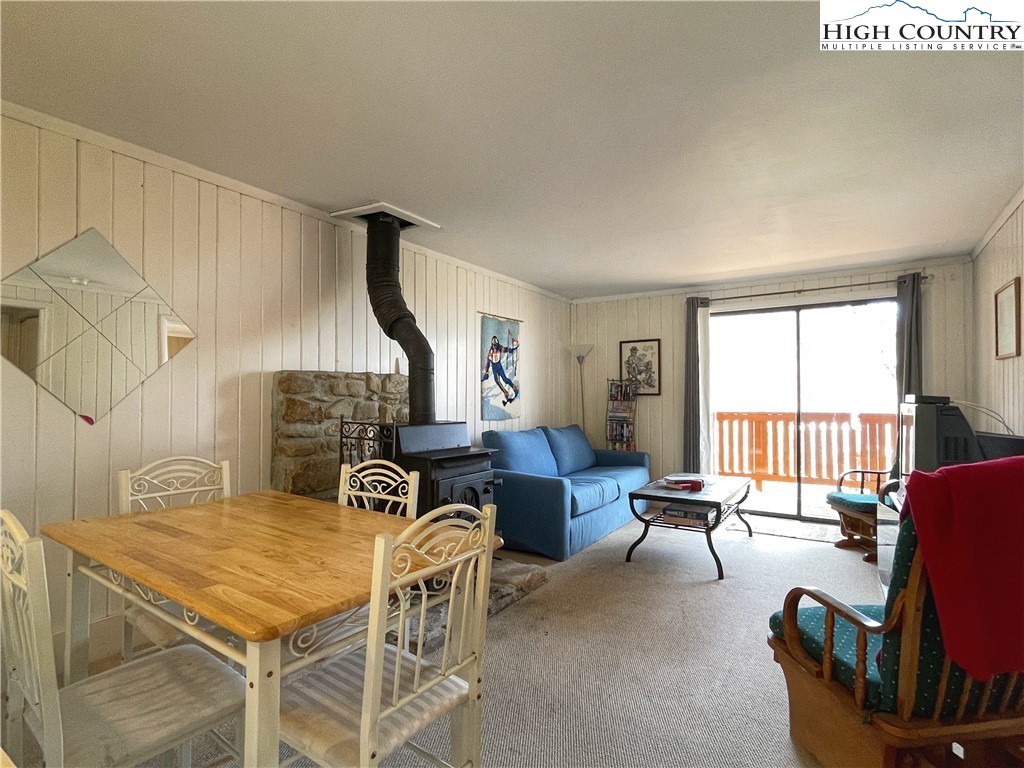 102 Skiview Lane, Unit A3 Beech Mountain, NC 28604 - Photo 7 of 20 a living room with furniture a fireplace and a potted plant