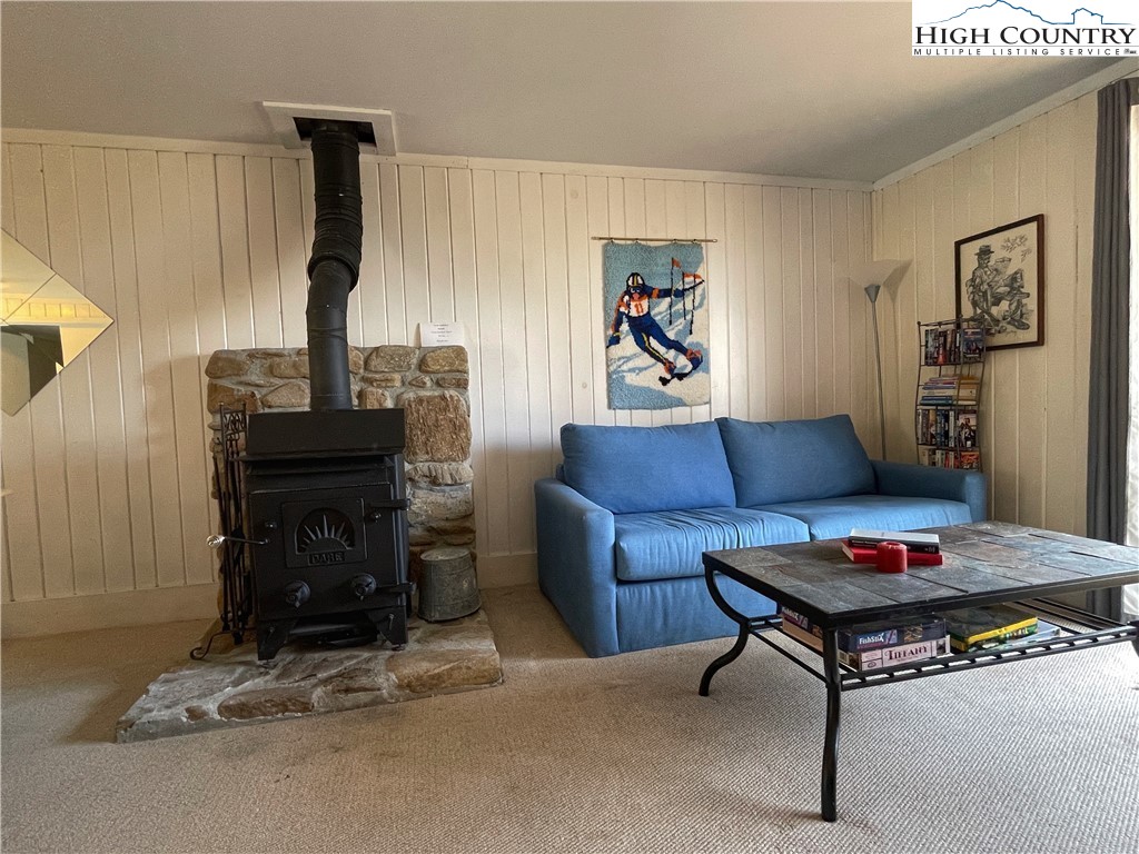 102 Skiview Lane, Unit A3 Beech Mountain, NC 28604 - Photo 8 of 20 a living room with furniture and a fireplace
