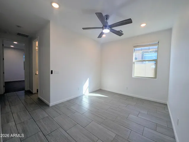 an empty room with closet and windows