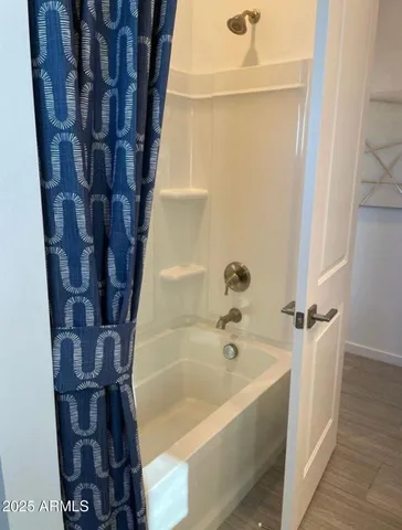 a view of walk in closet with empty racks