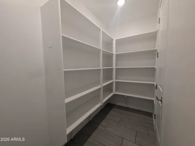 an empty room with a window and a ceiling fan