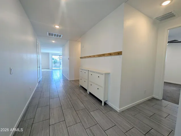 a view of a hallway with wooden floor