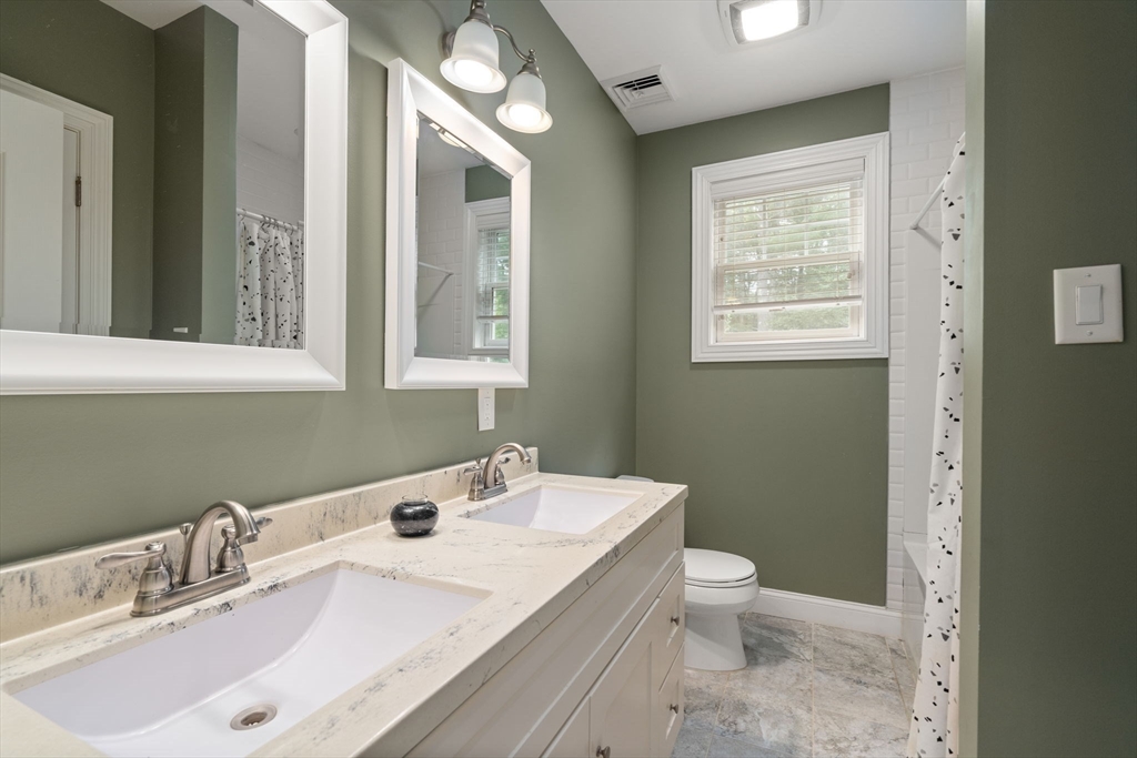 24 Wayside Inn Road Framingham, MA 01701 - Photo 27 of 38 a bathroom with a sink a toilet and a mirror