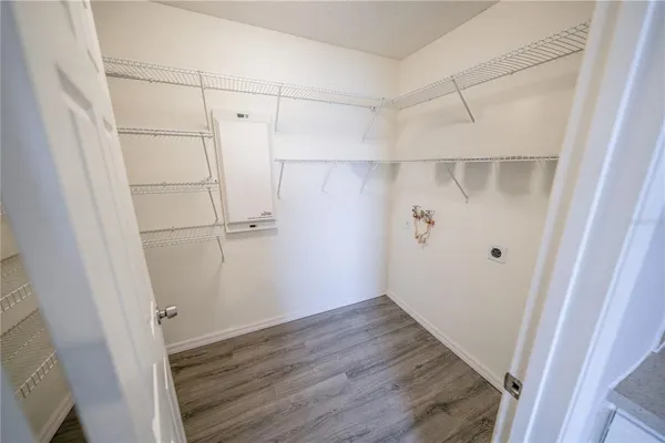 a view of walk in closet with empty racks