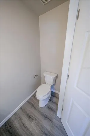 a white toilet sitting next to a shower