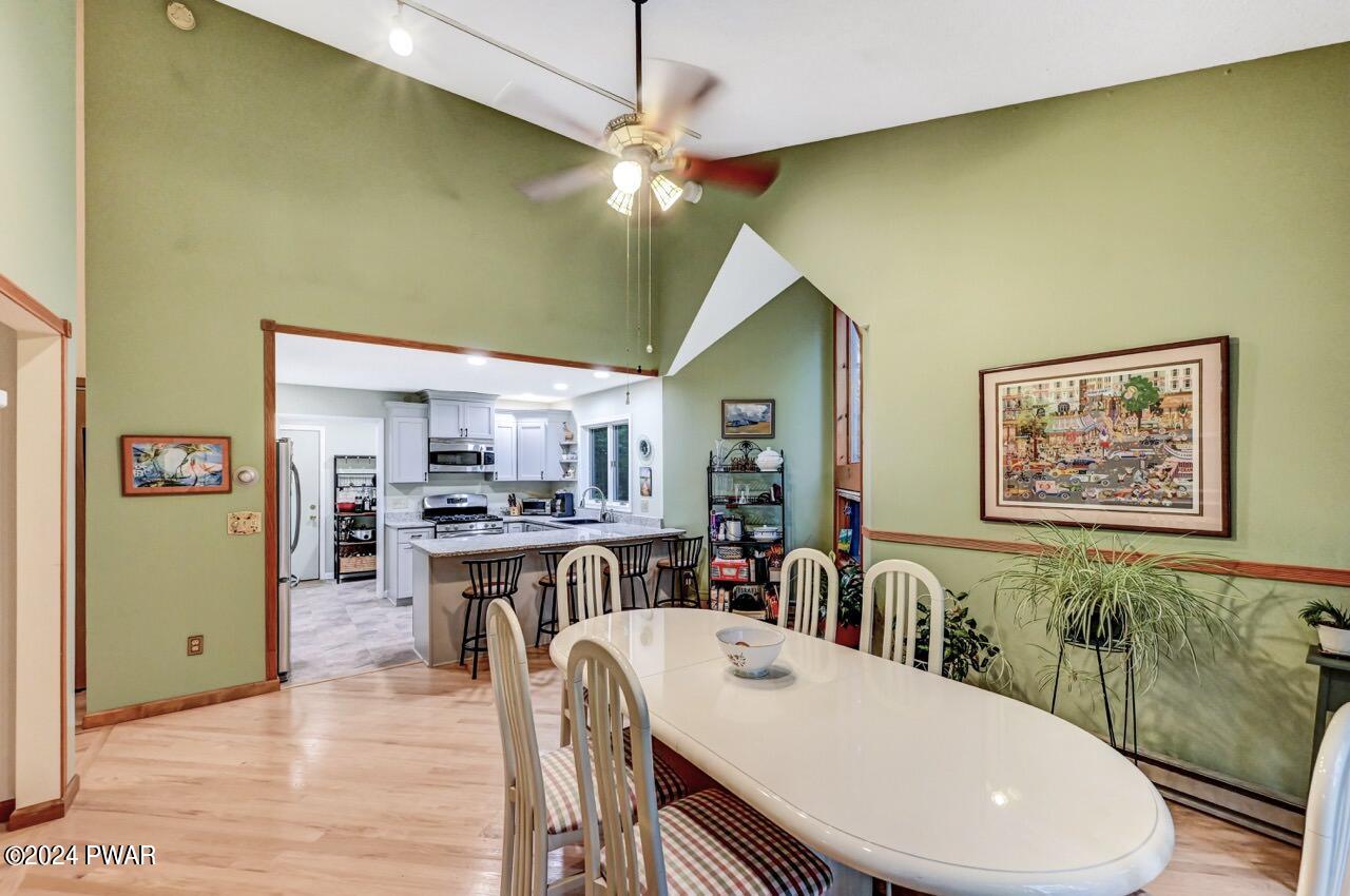 141 Maple Ridge Drive Hawley, PA 18428 - Photo 35 of 84 a view of a dining room with furniture and a chandelier fan