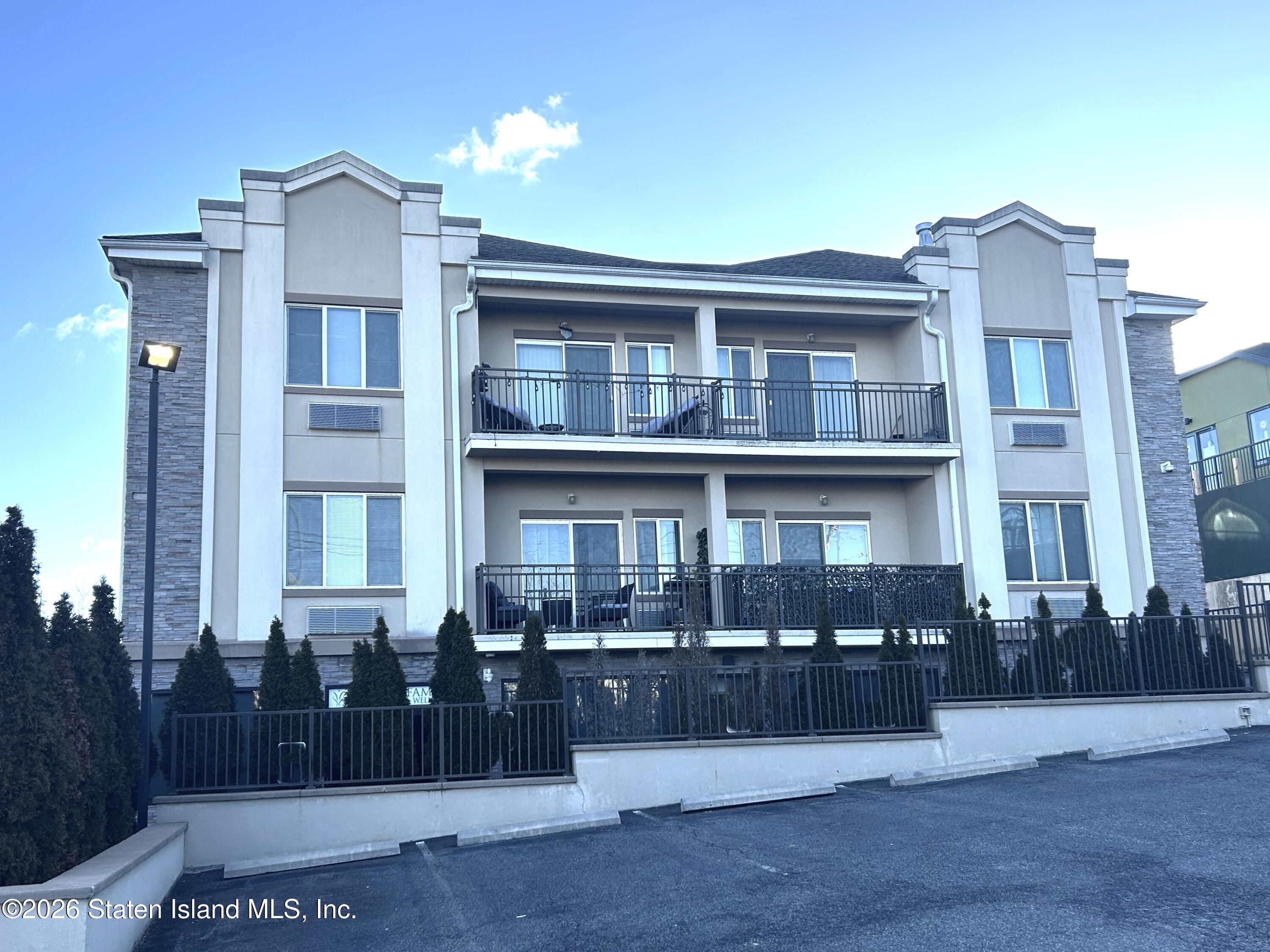 1235 Forest Hill Road, Unit 1G Staten Island, NY 10314 - Photo 2 of 11 a front view of a building with many windows