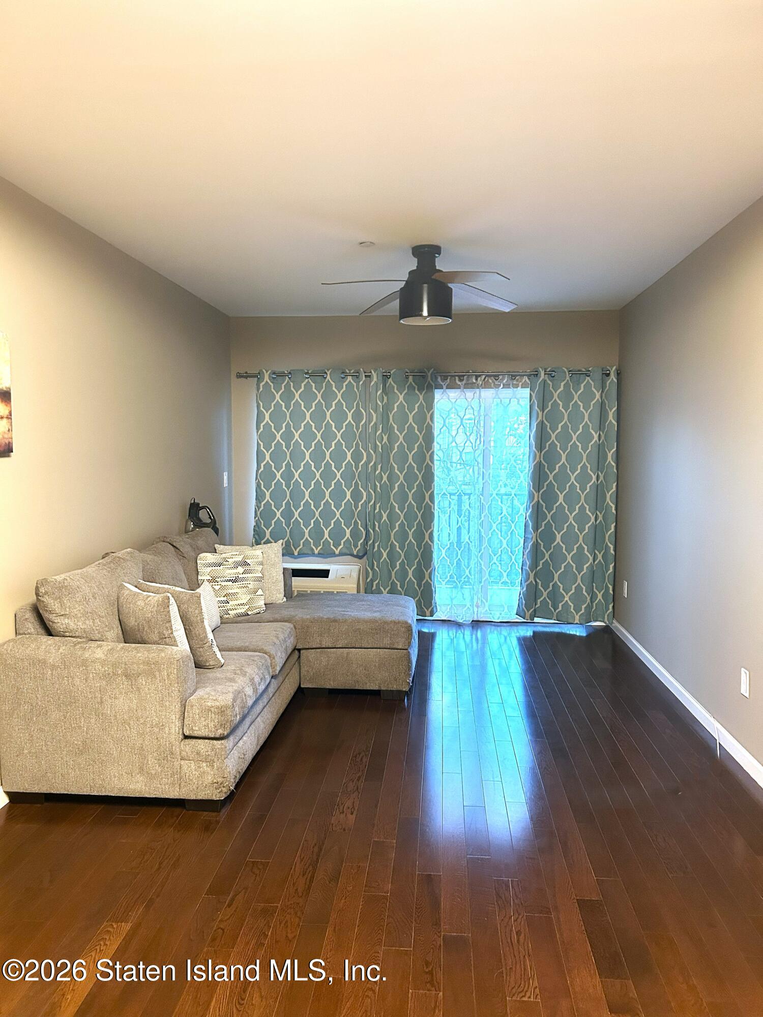 1235 Forest Hill Road, Unit 1G Staten Island, NY 10314 - Photo 4 of 11 a living room with furniture and wooden floor
