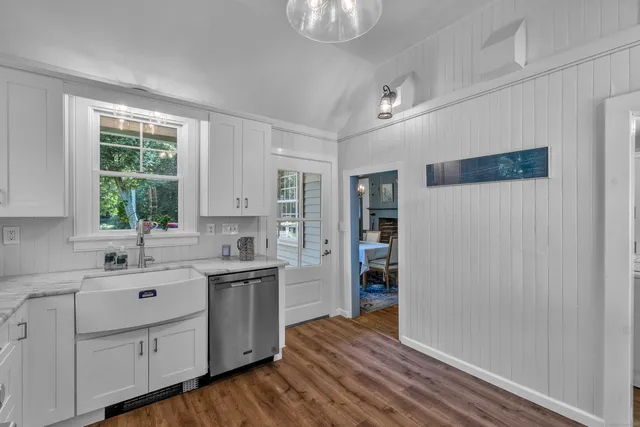 a kitchen with a stove sink and cabinets