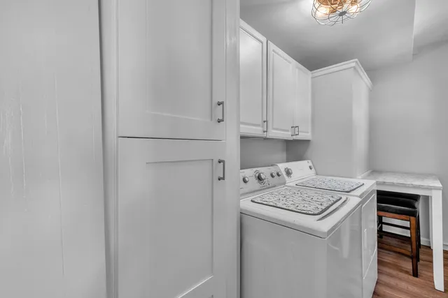a view of a dining room with furniture and chandelier