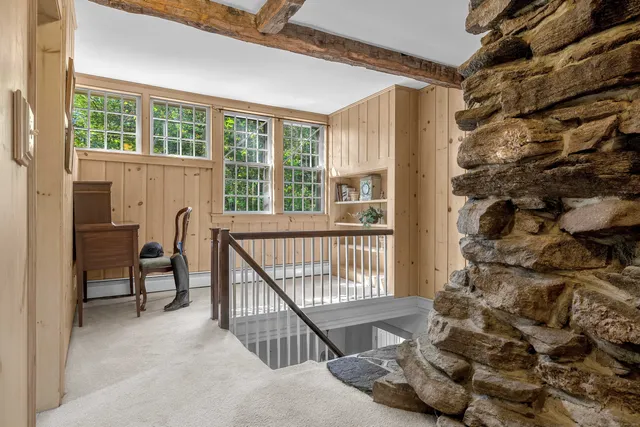 a bed sitting in a bedroom next to a window