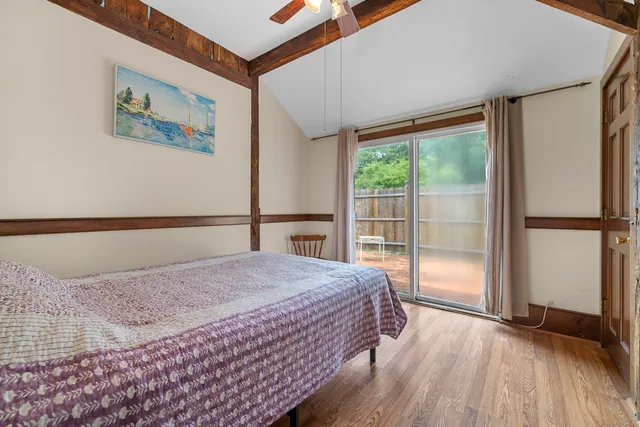 a view of backyard with wooden fence