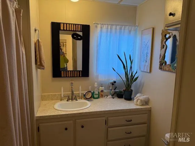 a bathroom with a sink mirror and toilet