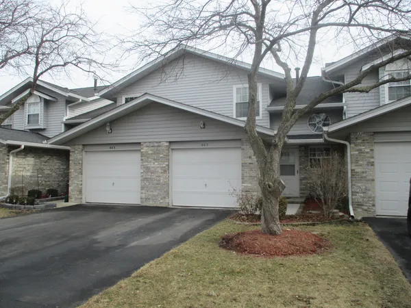 a front view of a house with garage
