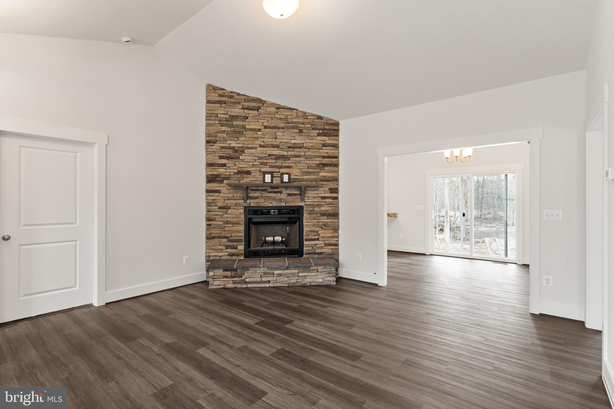 6735 Beverly Road Broad Run, VA 20137 - Photo 5 of 30 Unfurnished living room with a fireplace, dark woo