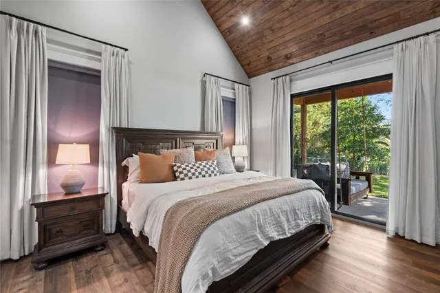 a bedroom with a large bed and a large window