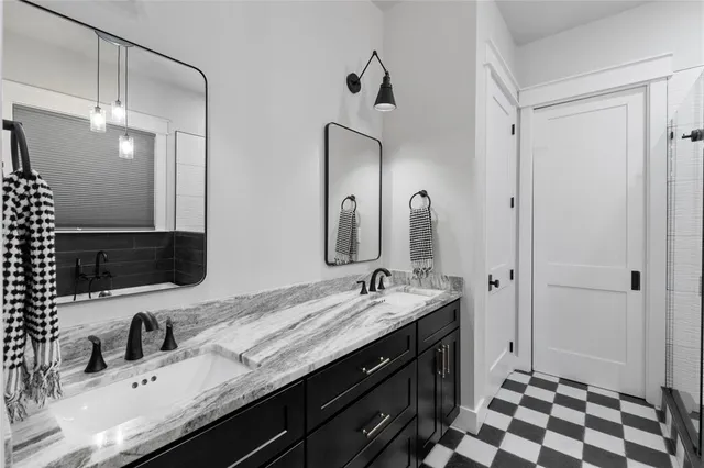 a bathroom with a double vanity sink and mirror