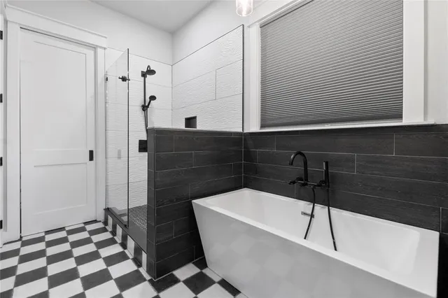 a bathroom with a bathtub and a shower