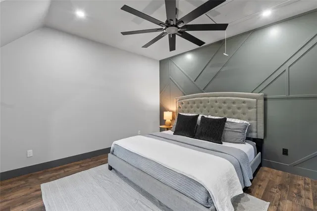 a bedroom with a bed and a ceiling fan
