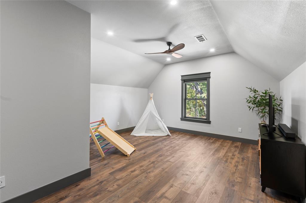 807 Midway Road Tool, TX 75143 - Photo 25 of 39 a view of an empty room with wooden floor and a window