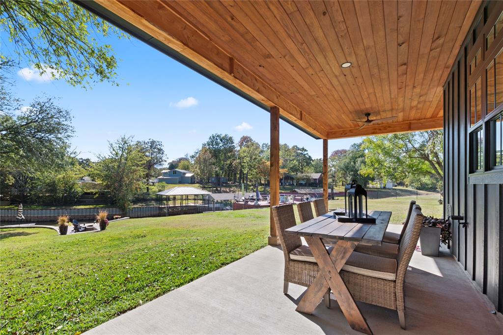807 Midway Road Tool, TX 75143 - Photo 28 of 39 a view of a patio with a table chairs and a backyard