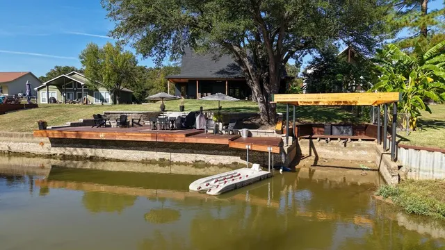 a view of a swimming pool with an outdoor seating and a yard