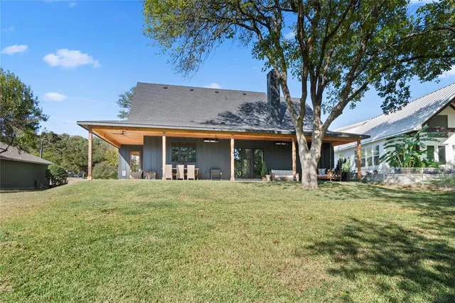 an aerial view of a house with a yard