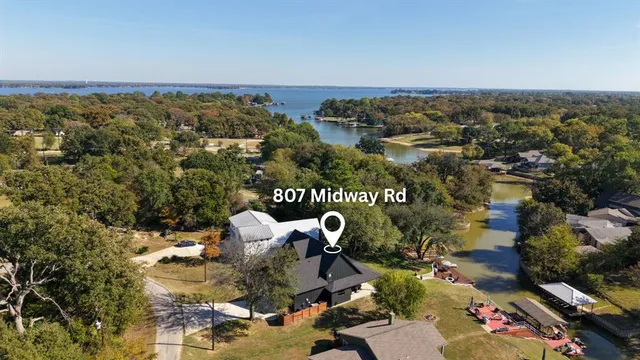 a view of a lake with houses next to road