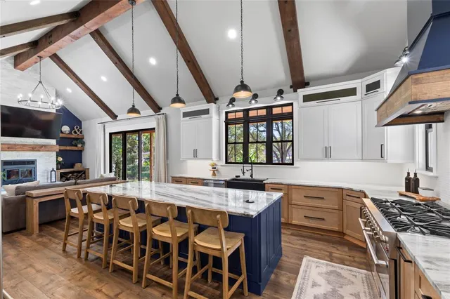 a kitchen with stainless steel appliances granite countertop a stove and a sink