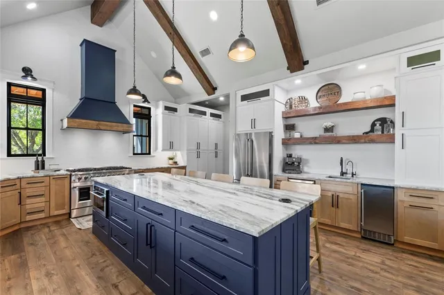 a kitchen with a stove and a wooden floor