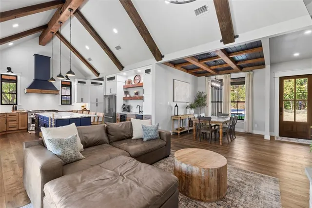 a living room with furniture and wooden floors