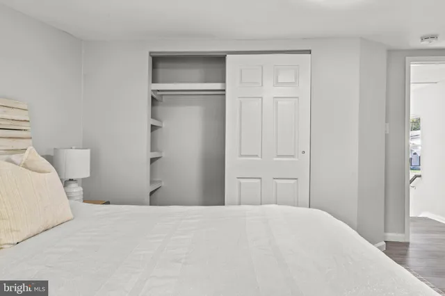 a bedroom with a bed and closet
