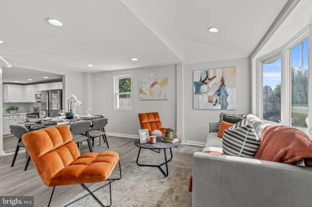 a living room with furniture a rug and a wall painting