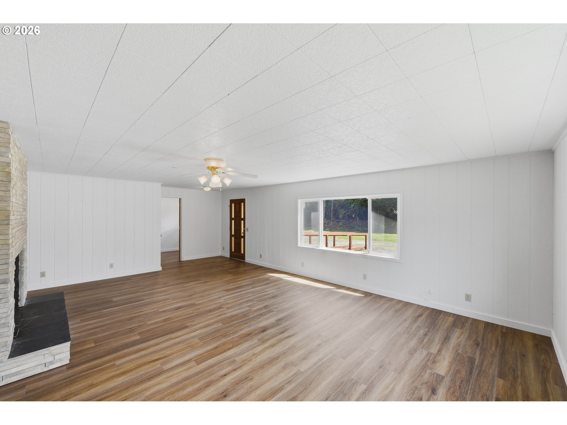 63299 Wildahl Road Coos Bay, OR 97420 - Photo 11 of 45 a view of an empty room with a window and wooden floor