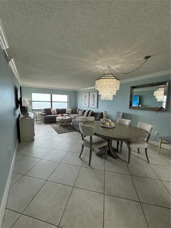 a living room with a bed furniture and a window
