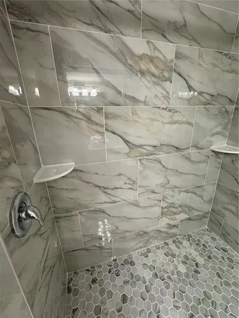 a bedroom with two beds and a lamp on table