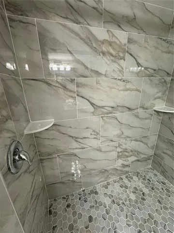 a bedroom with two beds and a lamp on table