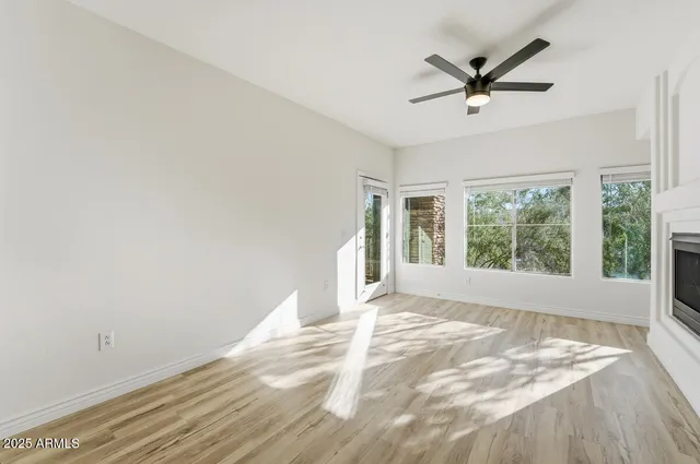 a view of a livingroom with a ceiling fan and window