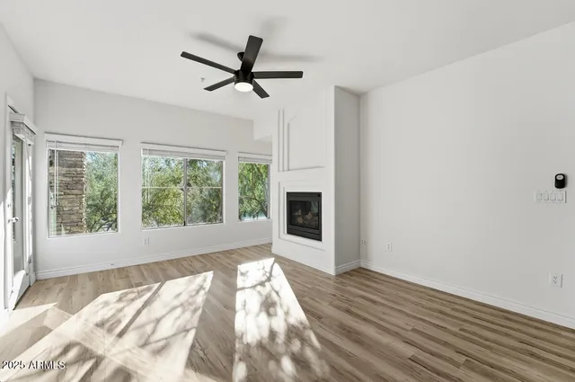 a view of a livingroom with a ceiling fan and window