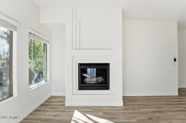 a view of a livingroom with a fireplace and window