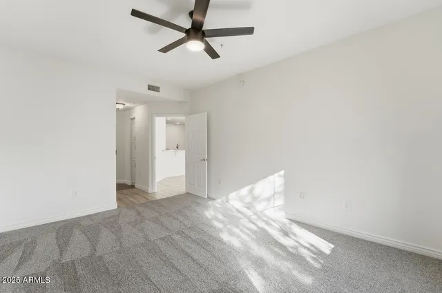 a view of a livingroom with a ceiling fan and window