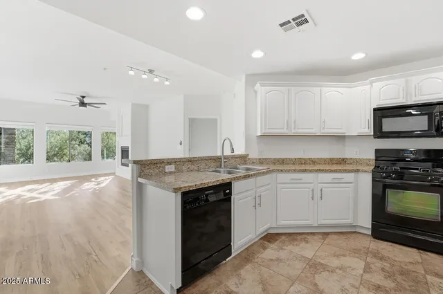 a kitchen with a stove sink and microwave
