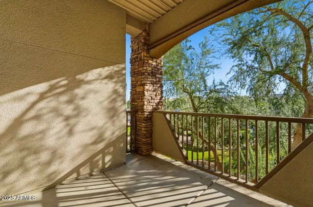 a balcony with trees in front of it