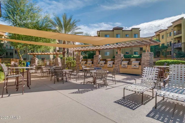 a view of a patio with a table and chairs and potted plants