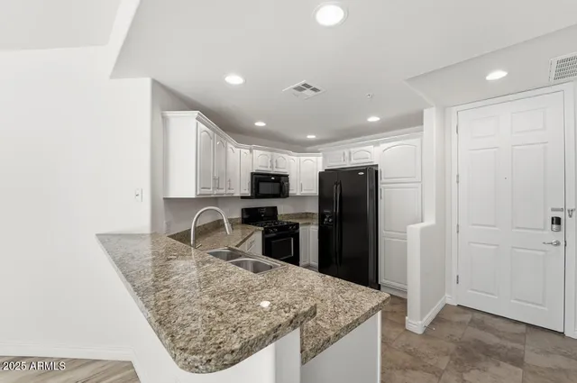 a view of kitchen island with cabinets