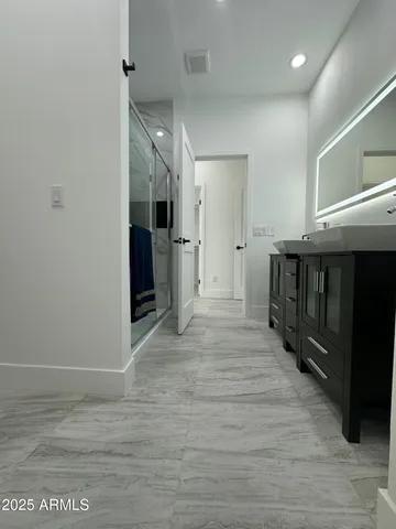 a view of a hallway with wooden floor and stairs