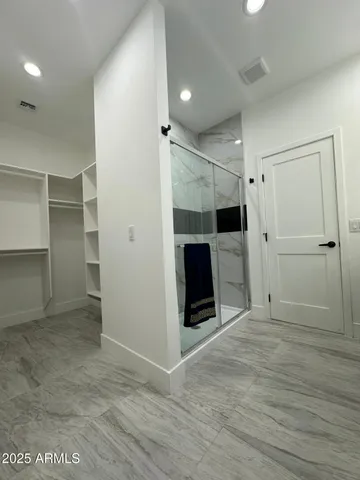 wooden floor in an empty room with a bathroom