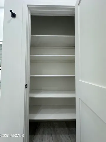 a view of walk in closet with empty racks